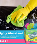 Person using a green microfiber cloth from a 120 Pack Microfiber Cleaning Cloths For Cars And Home Use Reusable Towels 11x9 Multicolor With Crazy Handy Dispenser Box Scratch Free Lint Free Washable Rags For Detailing And Polishing on a stovetop.
