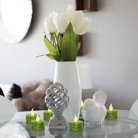 Green Glitter Flameless Tealight Candles 1.5 Inch By 1.65 Inch, Warm White LED Flicker, 12 Pack With Batteries Included on table