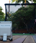 Outdoor setup of Golf Launch Monitor And Simulator Kit With 16 Data Points and 5D AI Radar facing The Net Return Pro Net.