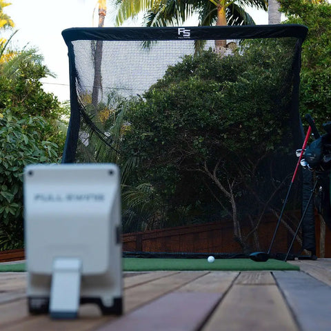 Outdoor setup of Golf Launch Monitor And Simulator Kit With 16 Data Points and 5D AI Radar facing The Net Return Pro Net.