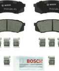 Bosch BC606 QuietCast rear ceramic brake pad set with hardware clips and lubricant.