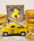 Sweet Little Yellow Honey Truck With Faux Dippers For Tiered Trays And Farmhouse Decor Chevy One Thirty Two Scale Diecast Vintage Pickup Bee Themed Shelf Or Table Decor For Kitchen And Bookshelf with honey jars and decor.