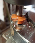 TJR countersink bit, 90°, orange-coated HSS, mounted in a drill press cutting metal