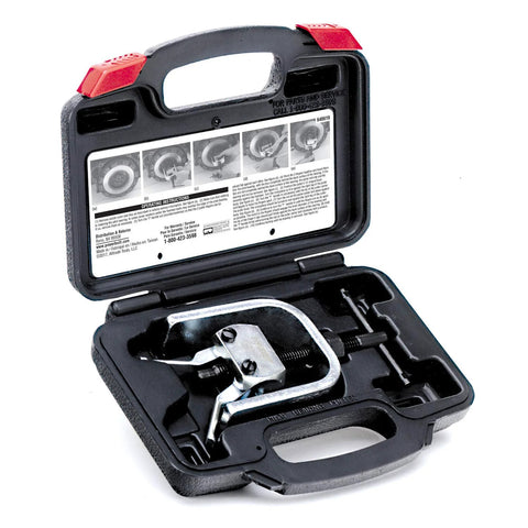 Powerbuilt pilot bearing puller kit in black storage case with red latches, silver puller visible.