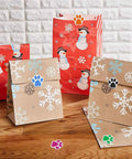 Dog Paw Print Stickers Roll 500 Self Adhesive Paw Labels on gift bags with snowflake and snowman designs, colorful animal shape decals