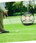 Man practicing on grass with Indoor Golf Practice Net For Home And Office Use Portable Swing Training Target Net Durable Foldable