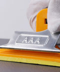 Close-up of a durable hand sander block with strong bite spring, showcasing clamp details for two pack sandpaper holder with sponge grip.