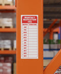 30 Pack Pro Grade Equipment Maintenance Inspection Stickers 5 By 3 Inch Monthly Log Labels attached to orange beam