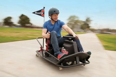 Person riding Crazy Cart XL Drifting Ride On Toy With High Torque Chain Driven Motor, Powder Coated Steel Frame, Extreme Drifts.