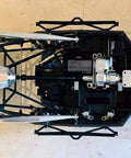 Top view of RC chassis showcasing hardened steel ring gear and planetary gear set, part of Traxxas UDR 1:7 scale transmission upgrade.