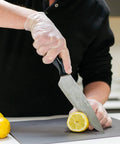 Heavy Duty Clear Vinyl Industrial Gloves Case Of 1000 Units 3 Mil Thick Build Large Roomy Fit used for chopping lemon.