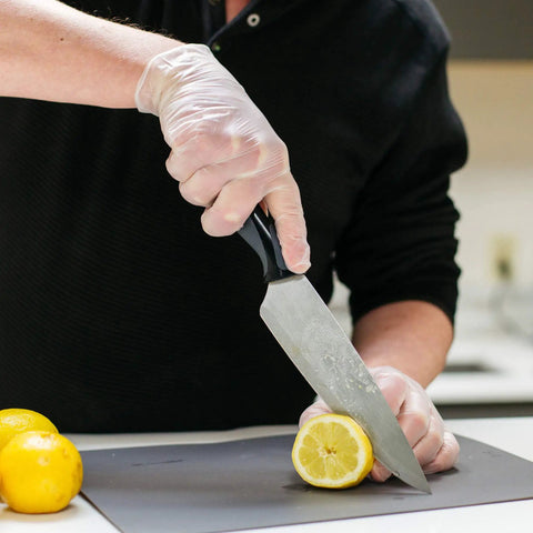 Heavy Duty Clear Vinyl Industrial Gloves Case Of 1000 Units 3 Mil Thick Build Large Roomy Fit used for chopping lemon.
