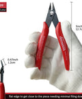 Five Inch Micro Flush Cutters Set Of Ten With Spring Loaded Action, red handles, close-up view, shown in gloved hand.