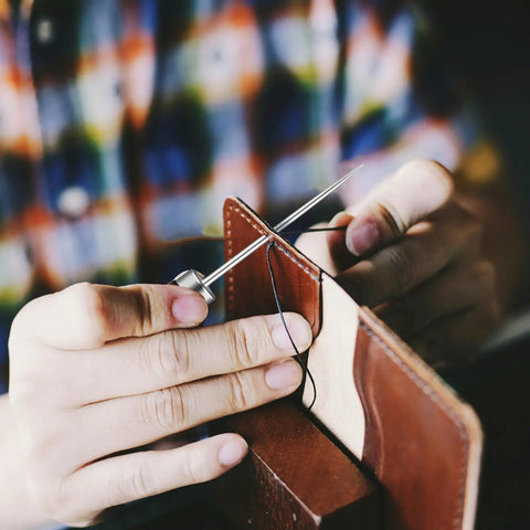 Person using Badass Professional Grade Three Pack Leather Awl Tools with grippy handles for precise leather stitching.
