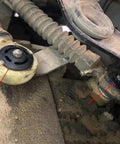 Close-up of installed 16mm and 22mm shift cable bushing kit for 5-speed manual transmissions fits Chrysler PT Cruiser 2001 2008 and Dodge Neon 2001 2008 gear shifter linkage repair replaces 5037380AA.