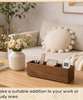 Wooden Desk Organizer With Six Compartments In Walnut Finish on a table, holding scissors, pens, and a small clock.