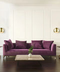 One Light Plug In Or Hardwire Wall Sconce With Vintage Glam Matte Brass Finish beside purple sofa in luxurious living room