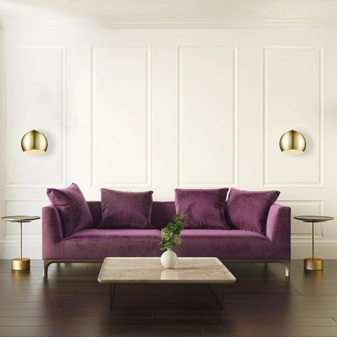 One Light Plug In Or Hardwire Wall Sconce With Vintage Glam Matte Brass Finish beside purple sofa in luxurious living room