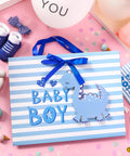 Blue Dinosaur Baby Boy Gift Bag with Tissue Paper and Greeting Card, durable ribbon handles, reinforced bottom, 13x10x5 inches.