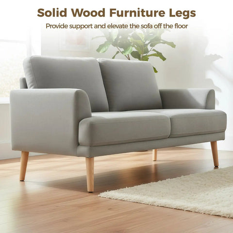 Solid Wood Furniture Leg Set 4 Pcs 7.9 Inch Angled Cone Legs With Anti Slip Pads in use under a grey sofa