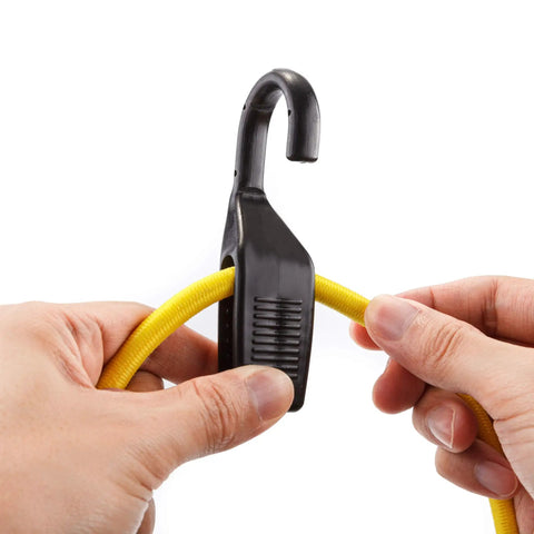 Close-up of hands holding 32-inch yellow cord from 18 Piece Adjustable Bungee Cord Set With Wide Hook Openings For Vehicle Tie Downs