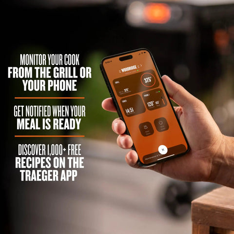 Person holding phone showing app interface for controlling Woodridge Pro Electric Wood Pellet Grill And Smoker For Backyard Grillin