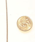 Close-up of 1/16 inch Heavy Duty Galvanized Aircraft Wire Rope Cable beside a quarter for size comparison.