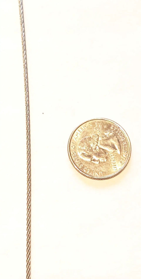 Close-up of 1/16 inch Heavy Duty Galvanized Aircraft Wire Rope Cable beside a quarter for size comparison.