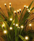Solar Firefly String Lights Waterproof Outdoor Decor For Yard, Patio, And Pathways, warm white LEDs among green foliage