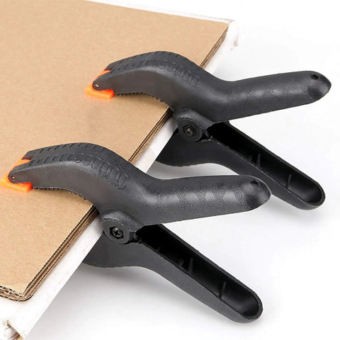 Six Pack 9 Inch Hefty Spring Clamps Made From Tough Nylon With Cushioned Jaw Tips engineered for knockout grip on cardboard.