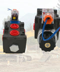 JAHEZYAN hydraulic solenoid diverter valve pair; black blocks with red port caps, blue wires, orange coil housing.