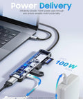 7 In 1 USB C Hub For MacBook And USB C Laptops With 4K HDMI 100W Power Delivery USB 3 0 Ports SD And TF Card Reader Space Gray Boss Level USB C Dock For Office Meetings Travel And Home Setup connected to laptop showing PD connection.