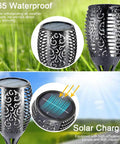 Outdoor Solar Torch Lights 4 Pack With 99 LED Flickering Flame IP65 Waterproof Garden Yard Decor Realistic Torch Effect For Halloween Patio Porch Pathway Lighting And Festive Vibe, showing solar charging and waterproof feature