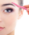 Close-up of woman using 24 Pack Eyebrow Razors With Precision Covers For Safe Facial Hair Removal And Neat Trimming.