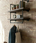 Wall-mounted pipe shelving with 10 Pack 1/2 In By 12 In Black Malleable Iron Pipe Nipples, decor items displayed.