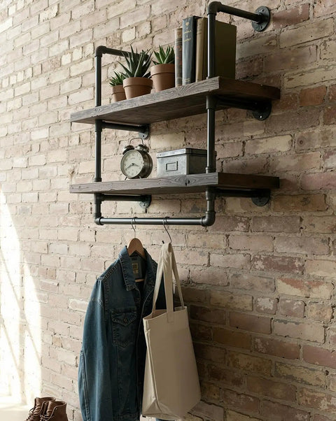 Wall-mounted pipe shelving with 10 Pack 1/2 In By 12 In Black Malleable Iron Pipe Nipples, decor items displayed.