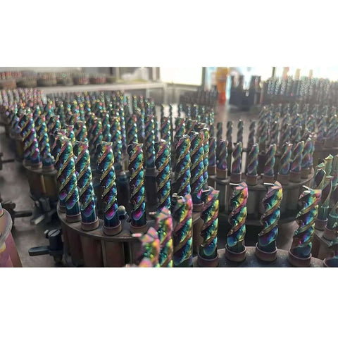 Close-up of rainbow DLC-coated 1/4in shank carbide end mills, 4in overall length, 3-flute; multiple bits shown.