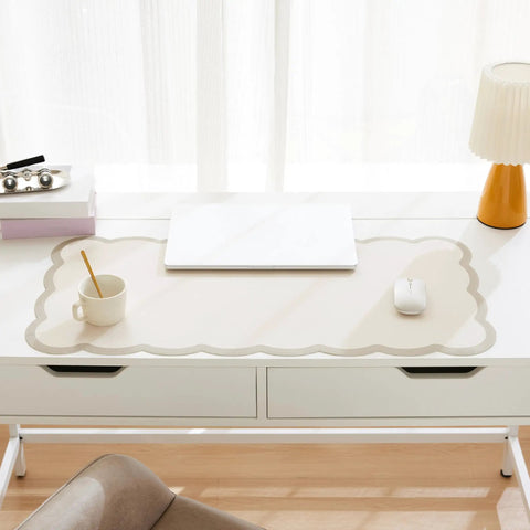 Stylish Scallop Edge Desk Mat Crafted From Smooth Faux Leather Blend With No Sweat Cleanup, beige pad on a white desk with a laptop.