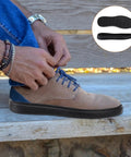 Man tying shoe with installed Full Soles Rubber Replacement For Sneakers And DIY Shoes Wear Resistant With Raised Grain Non Slip Pad