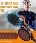 Man holding Electric Drywall Sander With Vacuum Dust Collection next to 8.5-inch hook and loop sanding pads