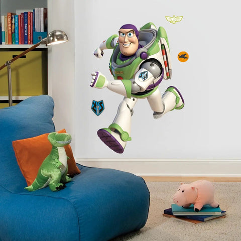 Buzz Lightyear Glow In The Dark Giant Peel And Stick Wall Decal in a kids' room below bookshelves.