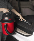 Person using 4 Gallon 4.0 Peak HP Wet Dry Shop Vacuum Grab-and-Go Portable with Wall Mount in car trunk cleanup