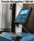 Tensile testing machine showing digital display, hose connection, and control panel for material testing over 500 lbf.