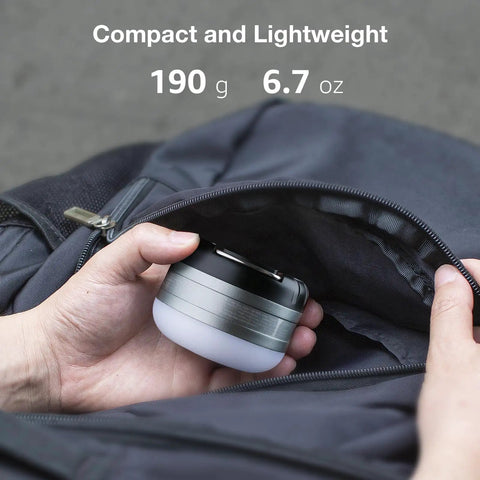 Compact Rechargeable LED Camping Lantern With 410LM Five Light Modes fits in backpack, showing portable design.