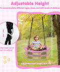 Child sitting on 40 Inch Pink Unicorn Saucer Swing for Kids With Adjustable Ropes and 2 Carabiners, outdoor setting, rope adjustment detail.