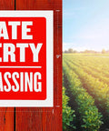 Private Property No Trespassing Signs 9x12 Inches Weatherproof And Water Resistant sign on wooden fence near a field