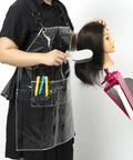 Transparent Waterproof Hair Stylist Apron With Adjustable Straps in use during hair styling on mannequin, 29.5 inch long