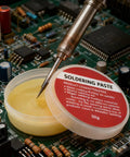 Soldering iron and 3 Pack 30G Soldering Flux Paste Rosin Flux No Clean Lead Free for PCB motherboard welding in use on a circuit board.