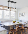 Sleek Black Three Light Pendant Fixtures Hit Different In Modern Kitchen Islands Or Dining Rooms Adjustable Clear Glass Shade Lamps With Killer Style over a dining table.
