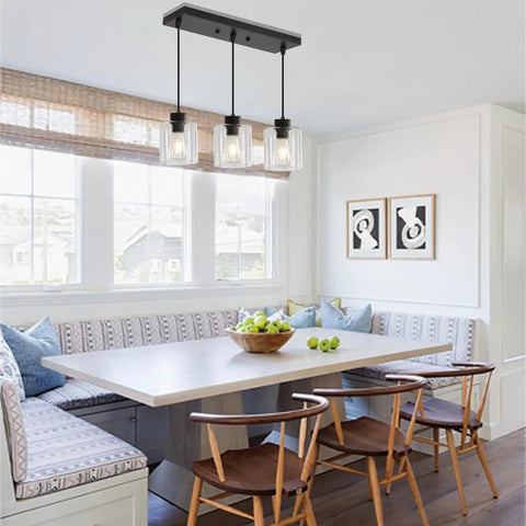 Sleek Black Three Light Pendant Fixtures Hit Different In Modern Kitchen Islands Or Dining Rooms Adjustable Clear Glass Shade Lamps With Killer Style over a dining table.